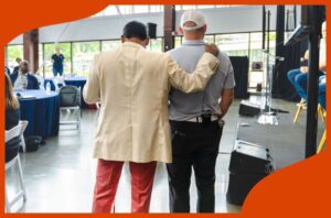 John and Mike walking and Mike is guiding John